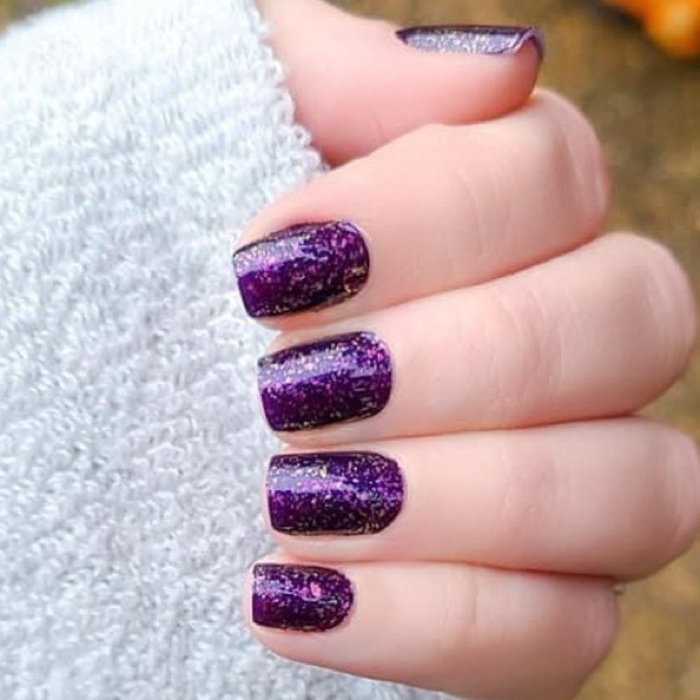 Color Street - Flake My Day, a bold deep eggplant, with lilac to gold fragments.